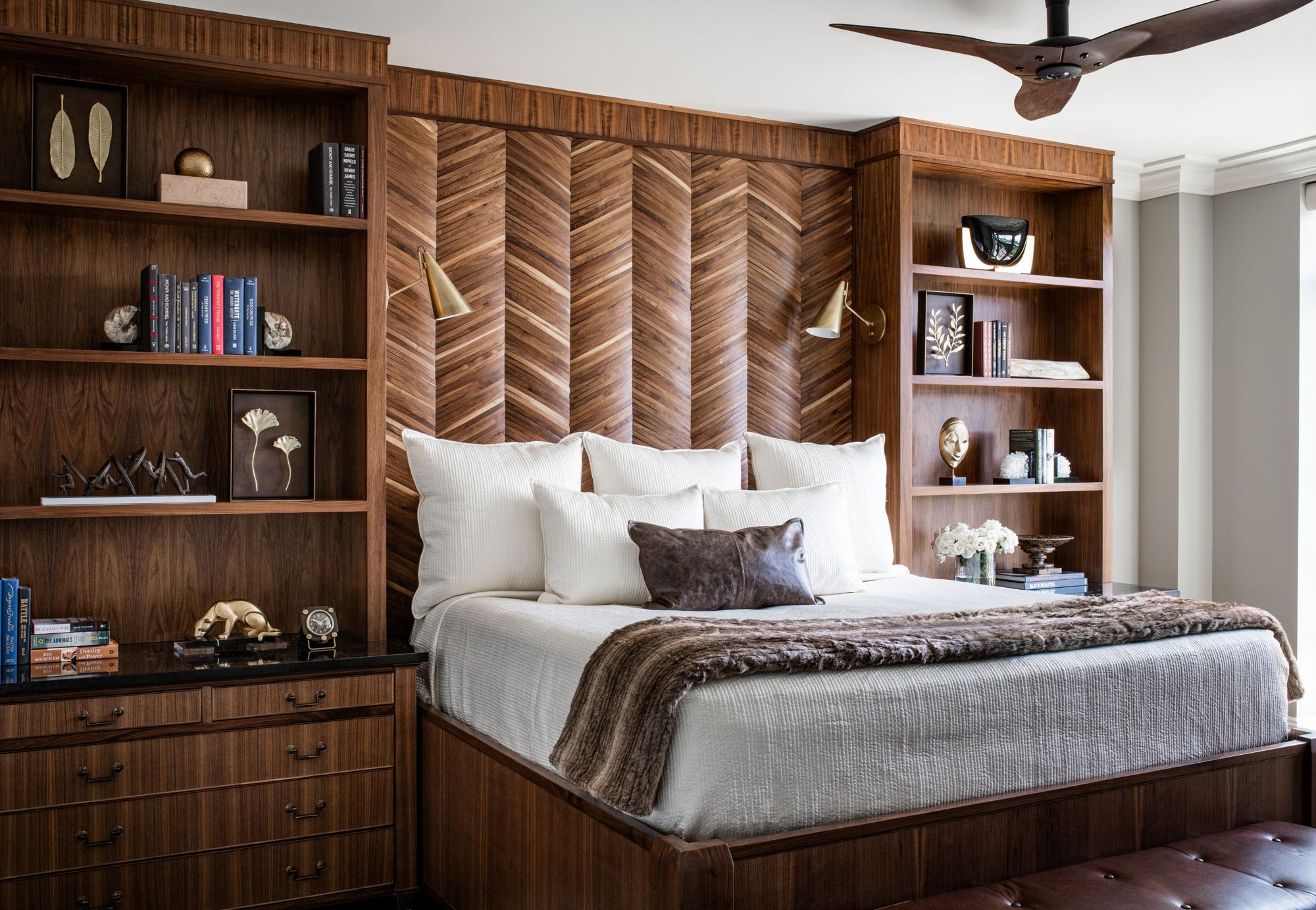 Bed with custom platform, headboard, and bookcases made with rich exotic woods. Designed by Jamie Merida.