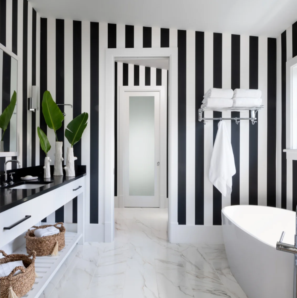 Bathroom design with soaker tub in front of a large window