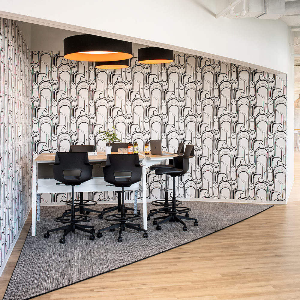 Commercial flooring project by Bountiful Flooring. Shows black and white conference nook with triangular carpet on light wood floors