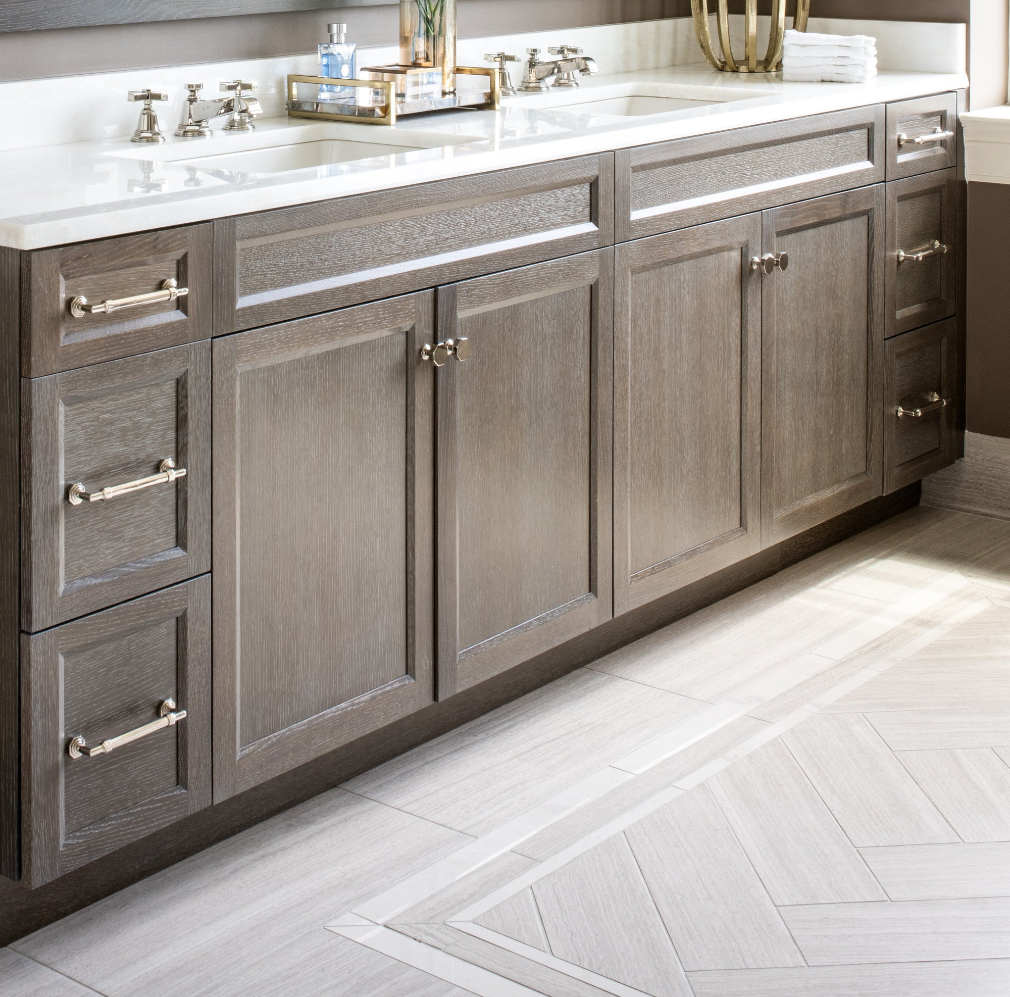 Bathroom floor with rug tile pattern in neutral tones. Designed and installed by Bountiful Flooring.