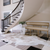 Curved staircase with plaid tile floor and hide rug. Bountiful Flooring in Easton, Maryland.