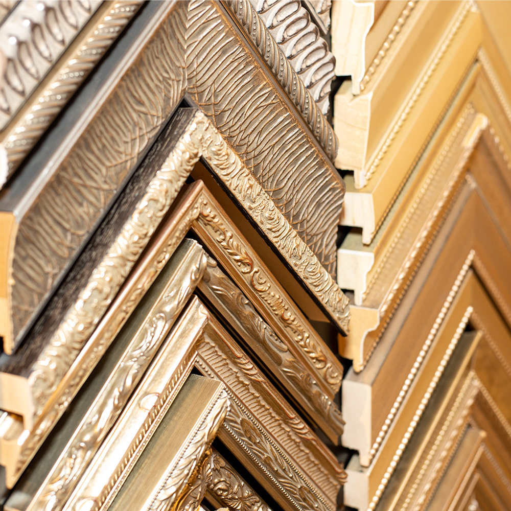 Close-up detail shot of gold-tone frames at Bountiful Framing in Easton, Maryland